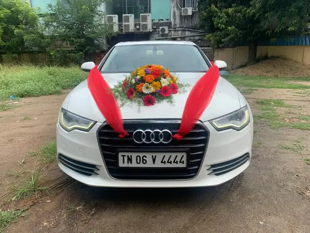 White Audi decorated with flowers as a wedding car in Chennai