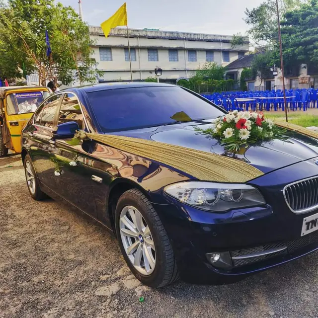 Blue BMW 5 Series wedding car with floral decoration in Chennai