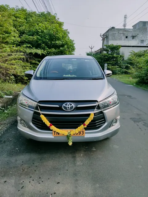 Silver Innova Crysta decorated with a marigold garland in Chennai