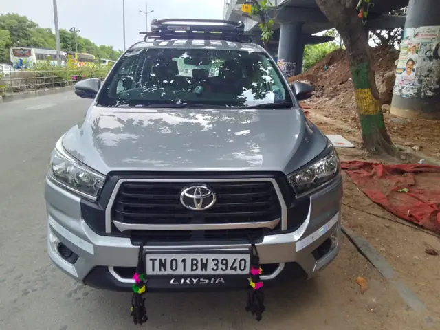 Silver Innova Crysta with roof carrier ready for an outstation trip from Chennai