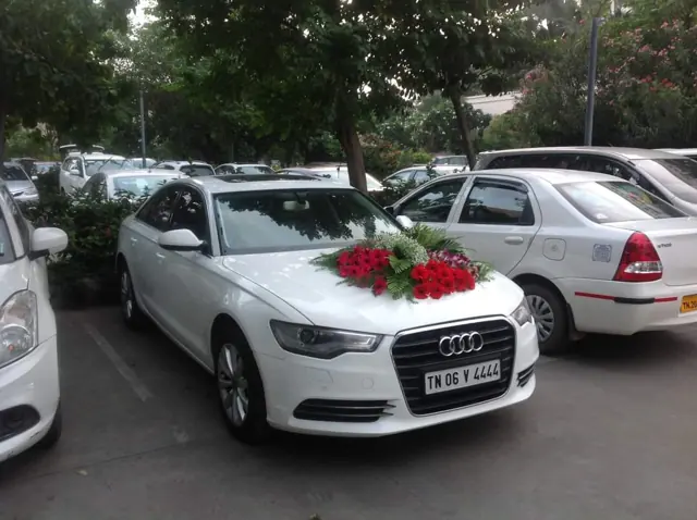 White Audi luxury wedding car with rose bouquet in Chennai